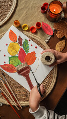 Autumn Crafting Scene with Colorful Leaves and Candle