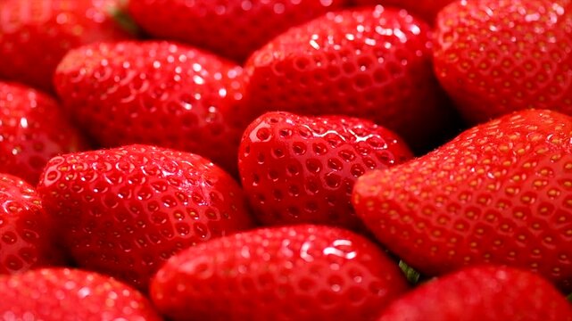 Strawberry, fresh ripe strawberries rotating background close-up. Organic Vegetarian healthy food backdrop, macro shot. Slow motion. 