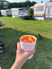 Refreshing drink in hand at summer campsite