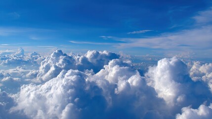 Fototapeta premium Vast expanse of fluffy white clouds drifting serenely across a brilliant blue sky, inspiring peace and wonder