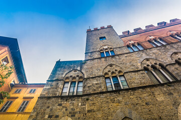 Naklejka premium Image of historic center in Siena featuring grand medieval buildings, monumental stone and brick facades, cultural landmarks and authentic Italian old town atmosphere