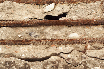 Cracked Stone Wall Detail. Close-up texture of cracked stone wall with deep lines, natural grunge background.