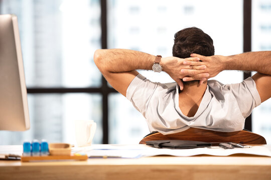 Businessman caucasian relax time after work  hard.  Man working and analysis report on financial data in the modern office, relax and rest time after work. Business Concept