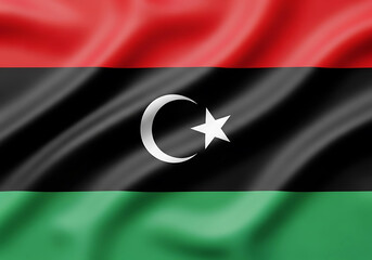 The waving flag of libya displaying its national colors and emblem