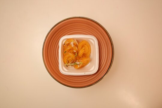 Paneer jalebi on white plate with minimal background