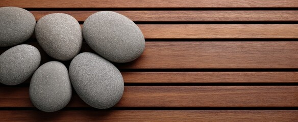 The pebbles on wooden slats create a zen spa minimalist background for relaxation