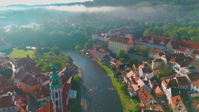 Aerial view of the historic town of Česk&yacute; Krumlov in the South Bohemian Region of the Czech Republic, showcasing its charming architecture, the Vltava River winding through the town, and the iconic Če