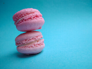 Pastel pink macaroons on blue background