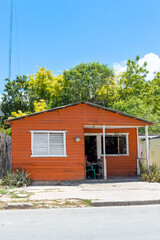 Pedernales, Dominican Republic, 8 august 2025. Typical Dominican Caribbean house made of wood, painted a bright red color.
