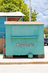 Pedernales, Dominican Republic, 8 august 2025. Typical Dominican cafeteria food truck made of wood, painted a bright green color.
