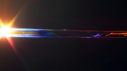 Lens flare with chromatic aberration on dark background horizontal light streak