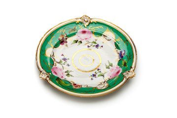 Antique porcelain plate with floral motif and gold plated decoration. Kornilov Brothers Porcelain Factory,, St.Petersburg, Russian Empire 1843-1861. Close-up view from above with white background. 