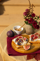 Fresh figs, cream cheese bruschetta on wooden table, Italian Bruschetta Menu, recipe, top view,