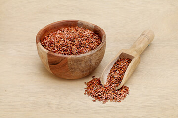 Bowl of flax seeds and wooden scoop