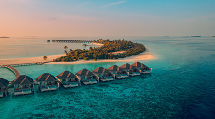 Perfect Maldives paradise sunset. Tropical aerial landscape, seascape, luxury water villas. Amazing...