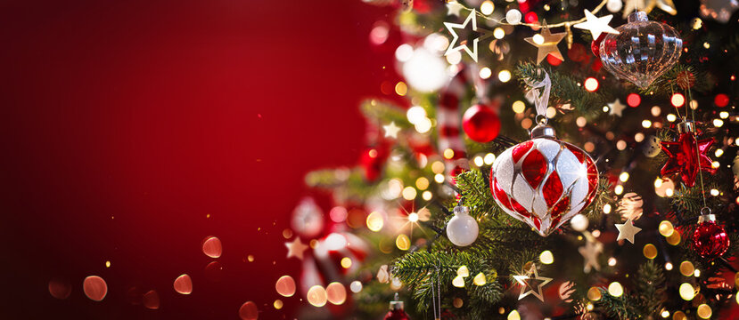 Christmas Tree with Lights and Garland. Glittery Christmas Tree with Garland and Decorations. Red Background - Powered by Adobe