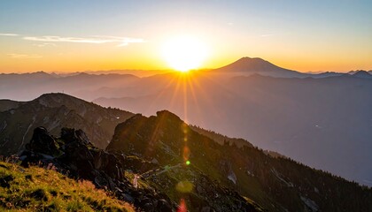 Obraz premium A scenic mountain range silhouette is bathed in the warm glow of a setting sun, casting long shadows