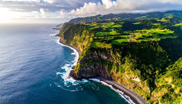 Aerial view of rugged coastline with lush green hills meeting the azure sea under a partly cloudy sky - Powered by Adobe