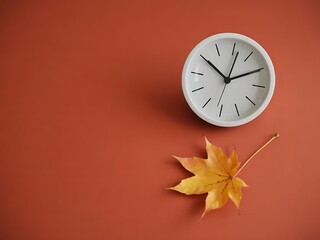 Modern minimal clock with autumn leaf creating cozy seasonal aesthetic for fall promotions and time management campaigns on warm terracotta background