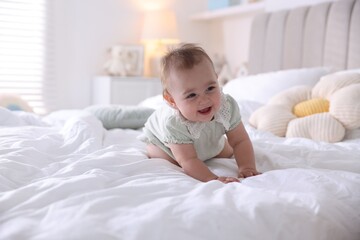 Cute little baby on bed at home