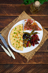 Omelette with toast, olives and sun-dried tomatoes. Tasty omelet breakfast