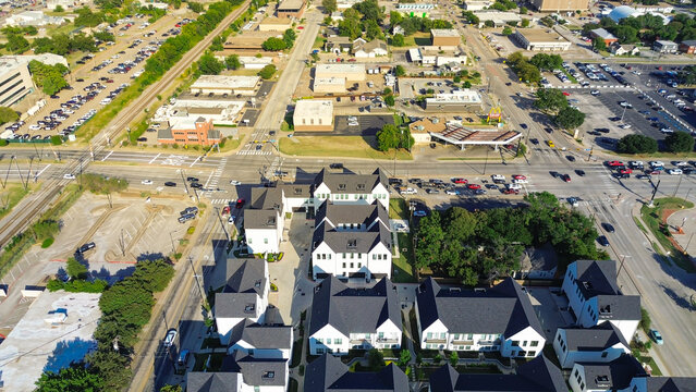 Fototapeta Unoccupied and busy outdoor parking lot from commercial buildings near Cooper, Abram and Main Street intersection mixed use zone in downtown Arlington, Texas, new development townhomes complex