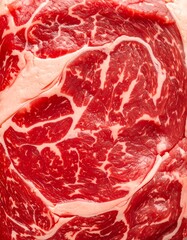 Close-up of a raw beef ribeye steak, showcasing marbling details