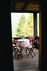 Table with chairs, Wooden deck, terrace, blacony, old traditional polish manson, house at Ojcowski National Park, Poland