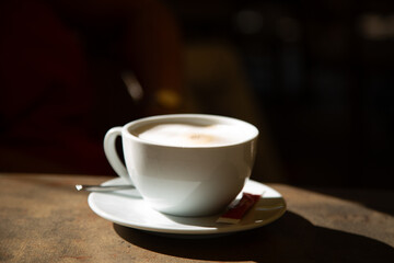 Early morning cappuccino in sunshine and shadow