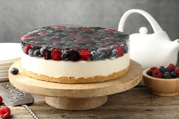 Delicious cheesecake with berries served on wooden table, closeup