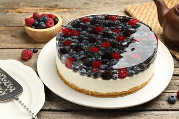 Delicious cheesecake with berries served on wooden table, closeup