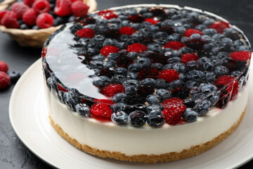 Delicious cheesecake with berries on black table, closeup