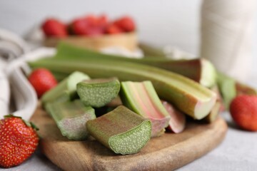Cut fresh rhubarb and strawberries on light table, closeup