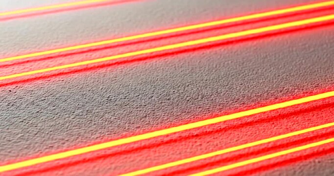 Abstract close-up of red laser lines on a textured surface, creating dynamic patterns