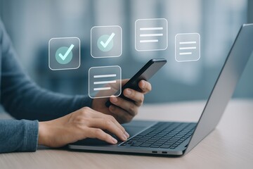Person using laptop and smartphone with task management icons for productivity and organization in office setting