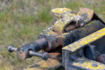 close up of rusty railway coupling device with yellow paint and weathered metal details