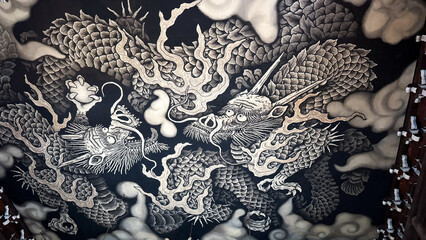 Grand Buddhist altar beneath a monochrome dragon mural © Leo