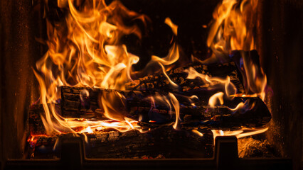 Warm flames dance in a cozy fireplace during a chilly evening