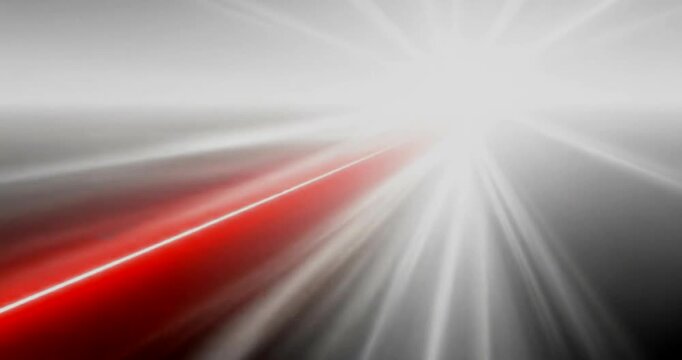 Abstract red laser beam cutting through dark space with light rays emanating