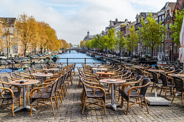 Outdoor dining area along scenic canal in Amsterdam