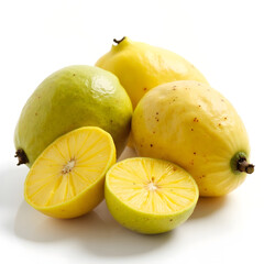 Close up of yellow and green fruits on a white surface