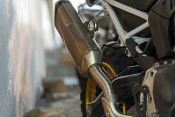 Motorcycle exhaust system showcasing detailed design in garage setting during the day