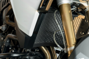 Close-up view of a motorcycle's radiator and engine components showcasing intricate design and engineering details