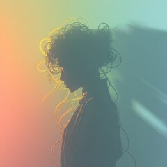 Silhouette of a woman with textured hair and blurred, gradient background
