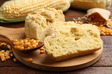 Freshly baked cornbread, cobs and seeds on wooden table, closeup