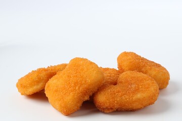 Many tasty chicken nuggets isolated on white