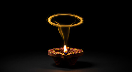 Traditional clay diya oil lamp lit with a golden flame and a ethereal smoke ring floating above. Concept of spiritual energy soul and transcendence against a black background for deepavali festival an