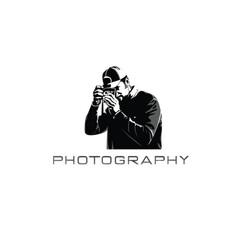 Man in baseball cap taking photo with vintage camera