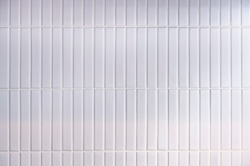 White ceramic tile wall background vertical grid pattern with grout lines