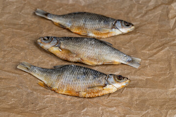 dried fish for long-term storage by dehydrating whole fish in the sun, product of dehydrated and dried fish in scales ready for human consumption
